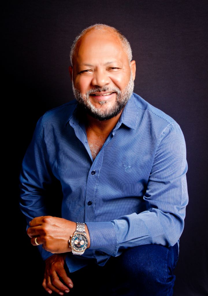 Dr. José Márcio Alves sorrindo, de camisa azul